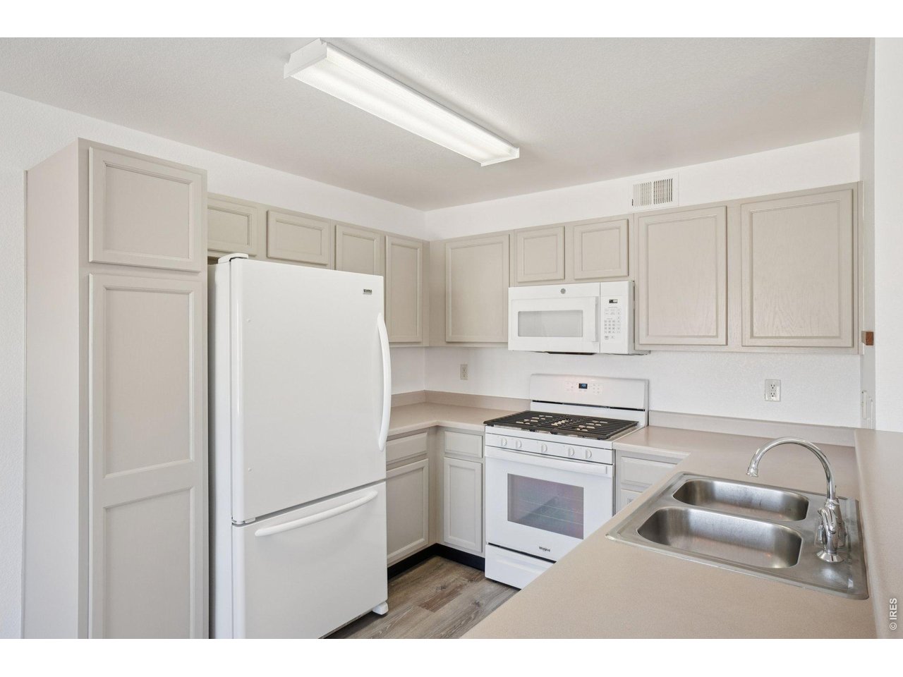 3002 West Elizabeth Street, Unit 16G Fort Collins, CO 80521 - Photo 11 of 29 a white refrigerator freezer sitting in a kitchen