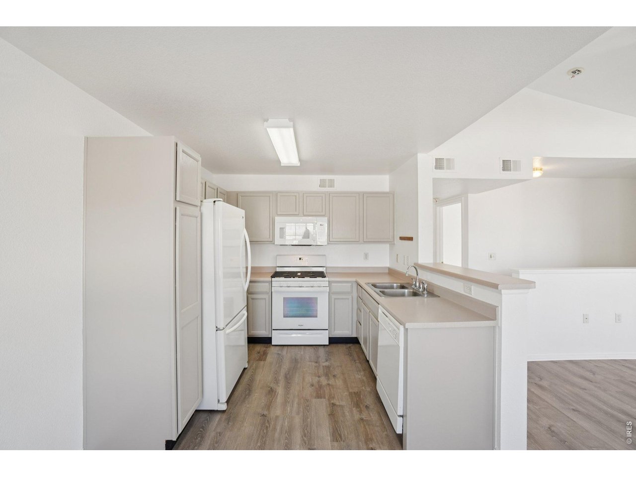 3002 West Elizabeth Street, Unit 16G Fort Collins, CO 80521 - Photo 12 of 29 a kitchen with white cabinets appliances and stove