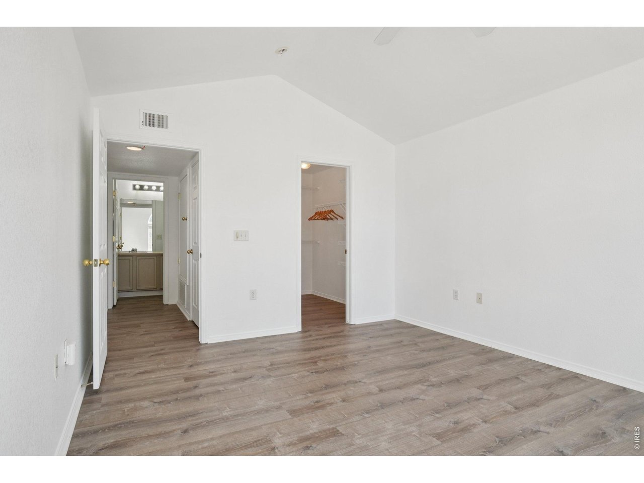 3002 West Elizabeth Street, Unit 16G Fort Collins, CO 80521 - Photo 18 of 29 a view of an empty room with wooden floor