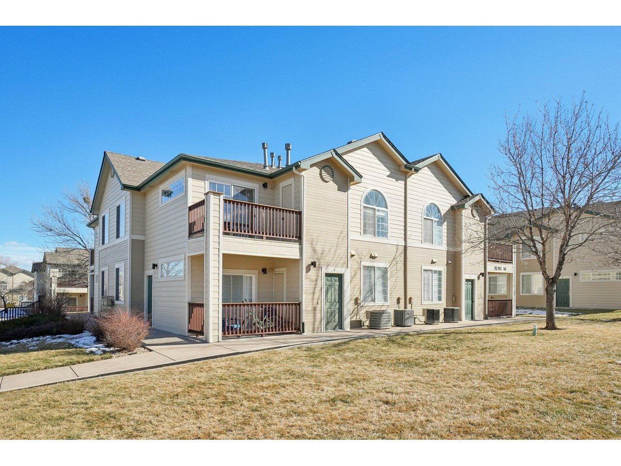 3002 West Elizabeth Street, Unit 16G Fort Collins, CO 80521 - Photo 3 of 29 a view of a white house with a yard