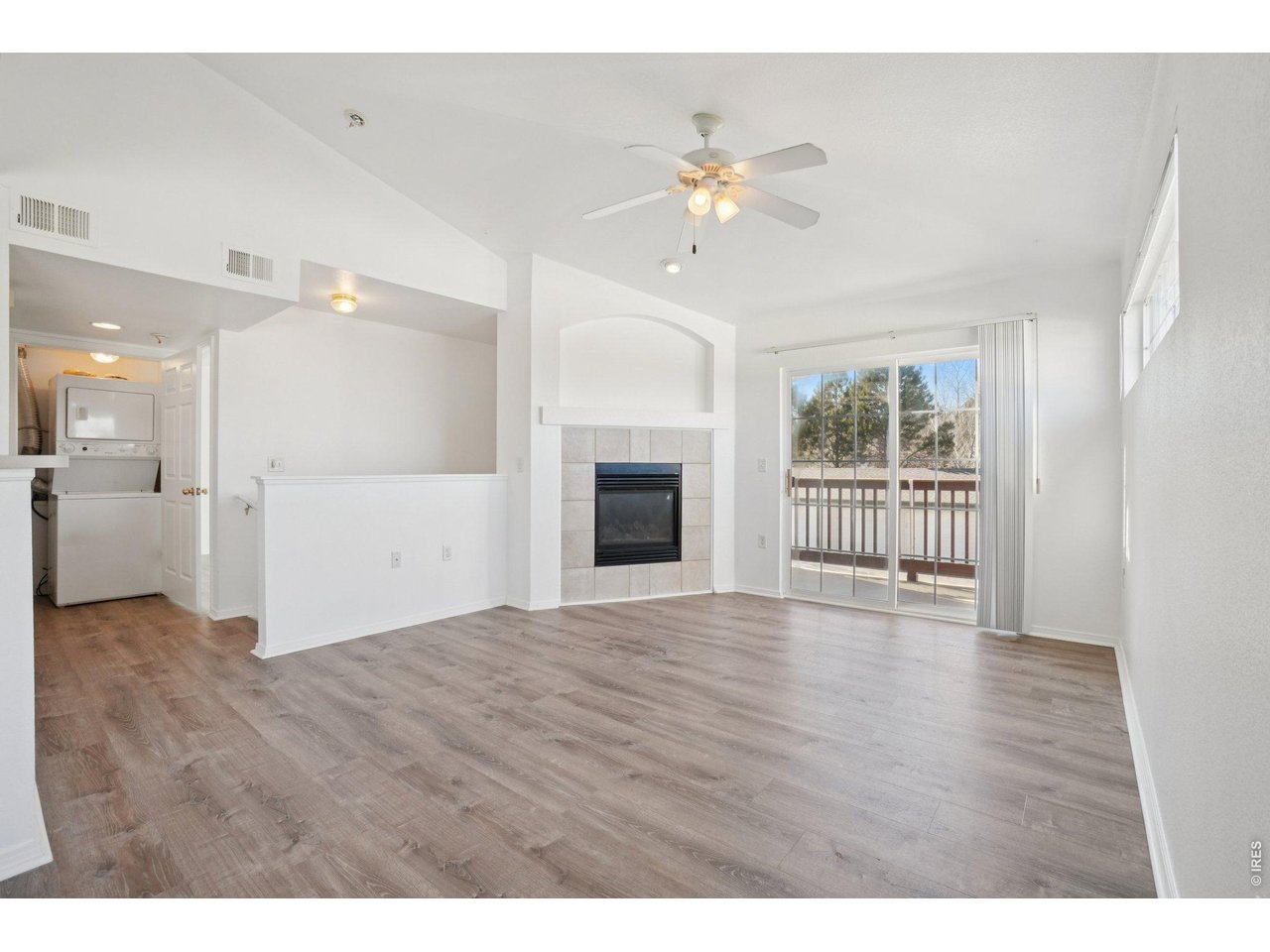 3002 West Elizabeth Street, Unit 16G Fort Collins, CO 80521 - Photo 6 of 29 a view of an empty room with a window and wooden floor