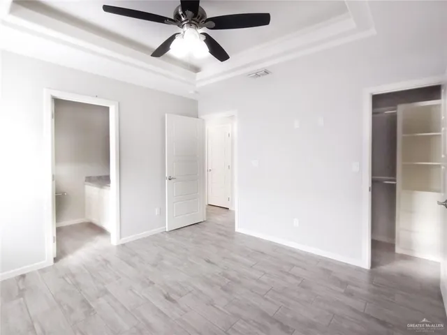 a view of an empty room and closet area
