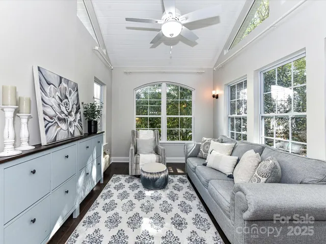 a living room with furniture and large windows