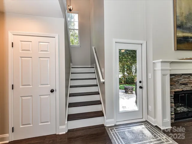a view of entryway with wooden floor and front door