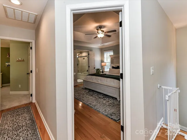 a view of a hallway with a living room and a bathroom