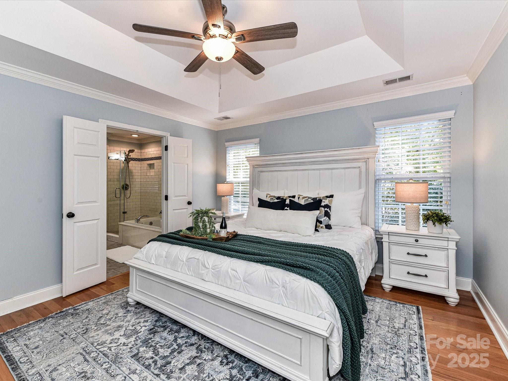 129 Shorecrest Drive Davidson, NC 28036 - Photo 24 of 45 a bedroom with a bed and a chandelier