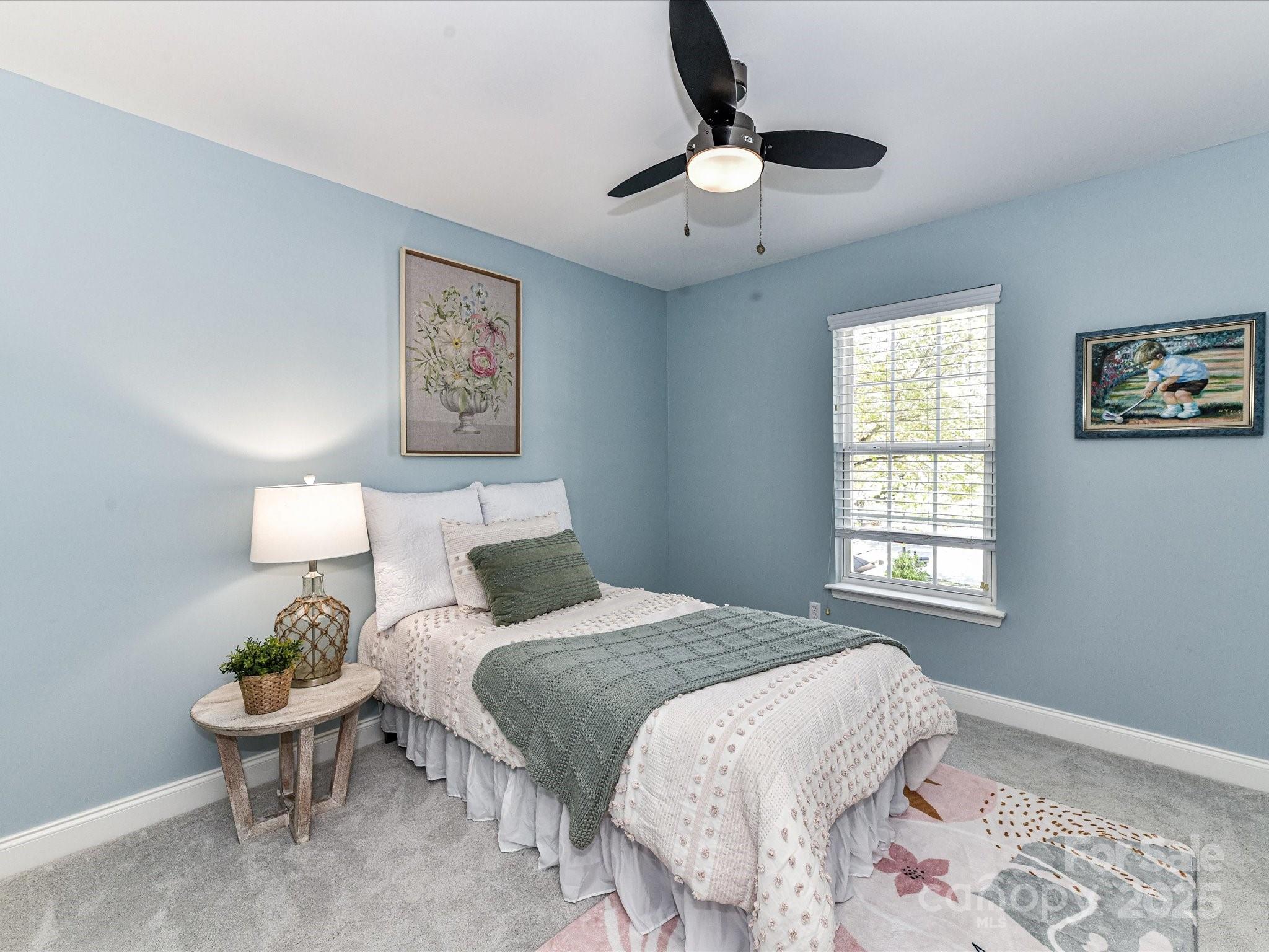 129 Shorecrest Drive Davidson, NC 28036 - Photo 28 of 45 a bedroom with a bed and a chandelier