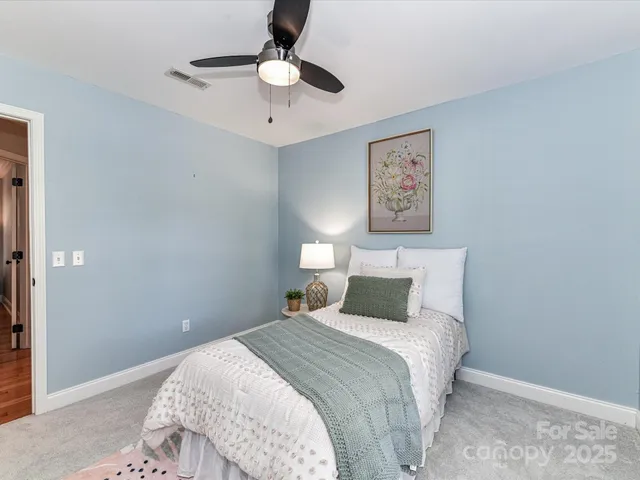 a bedroom with a large bed and a chandelier