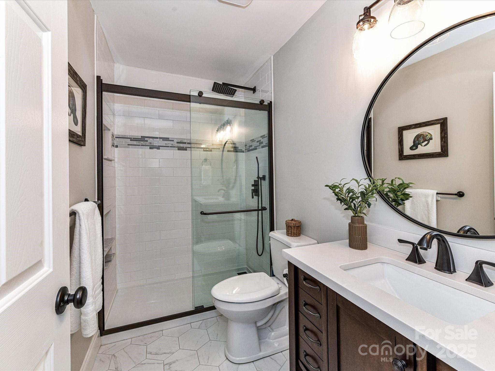 129 Shorecrest Drive Davidson, NC 28036 - Photo 30 of 45 a bathroom with a granite countertop sink toilet and shower