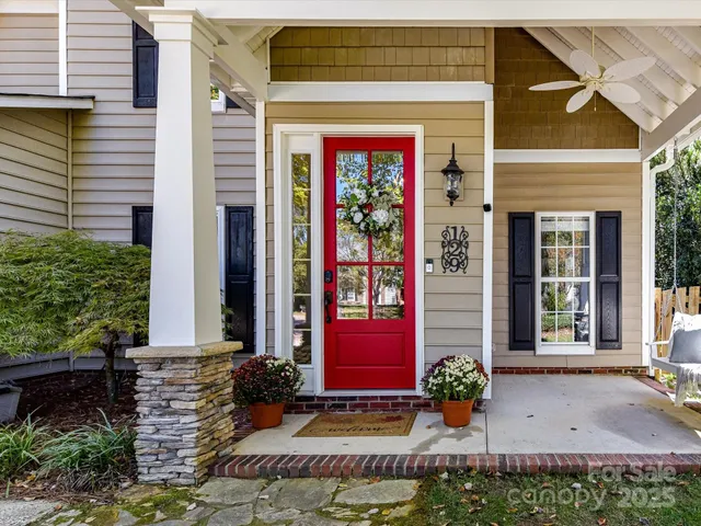front view of a brick house with potted plants