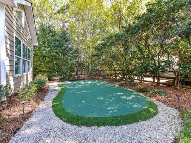 a view of a garden with large trees