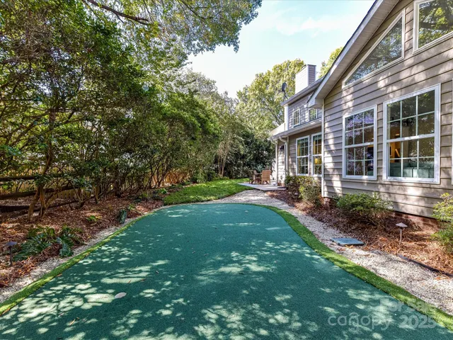 a view of a patio with table and chairs and potted plants