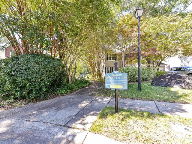a front view of a house with a yard and fountain