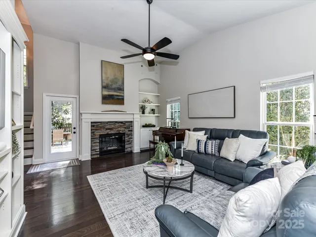 a living room with furniture fireplace and window