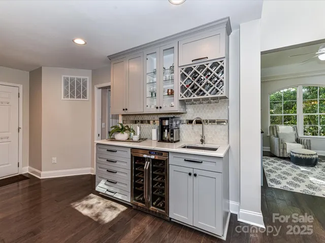 a kitchen with kitchen island granite countertop a sink cabinets and wooden floor