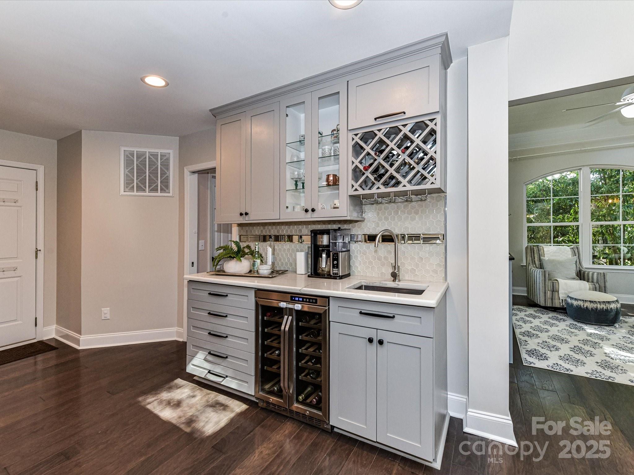 129 Shorecrest Drive Davidson, NC 28036 - Photo 10 of 45 a kitchen with kitchen island granite countertop a sink cabinets and wooden floor
