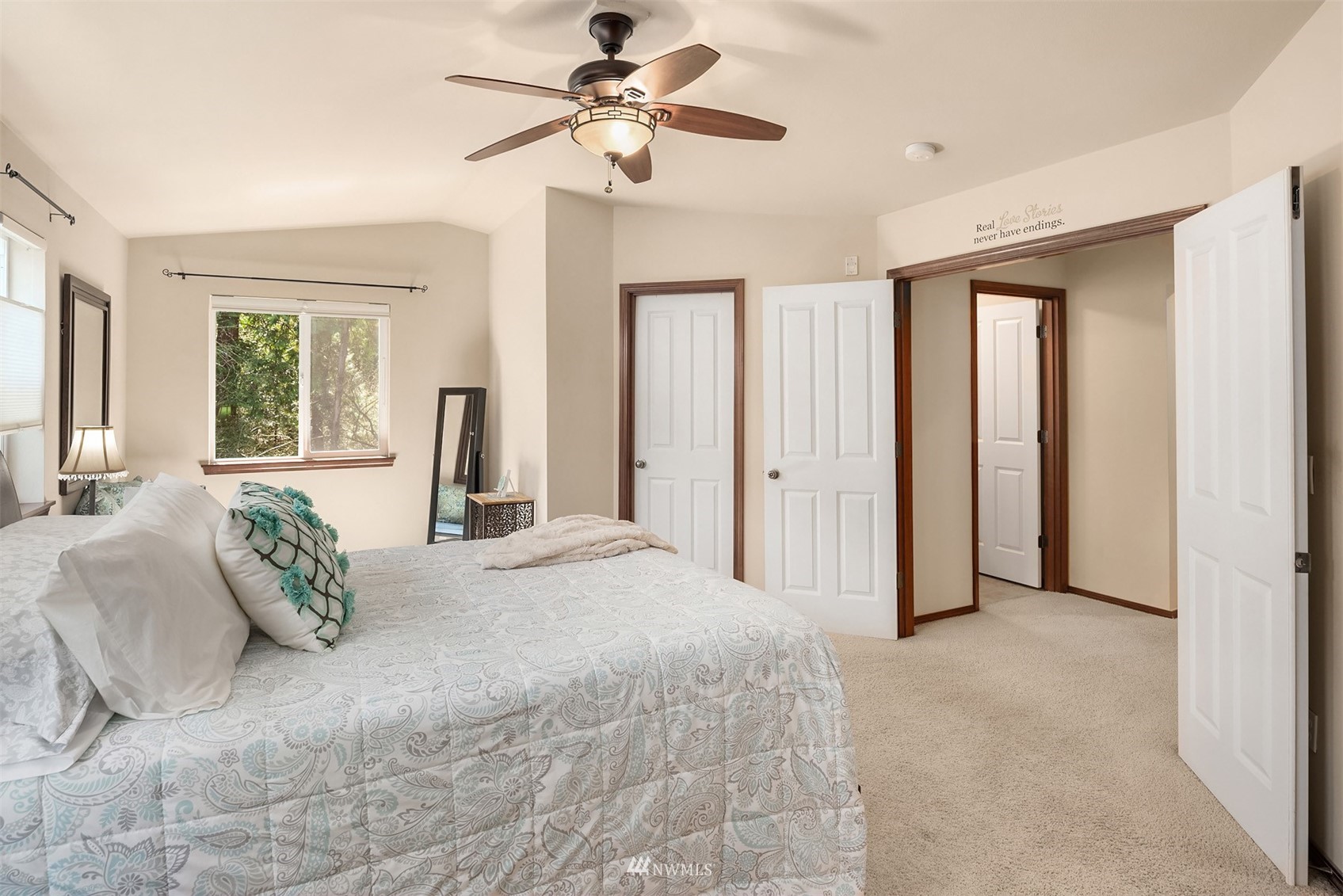 21614 11th Drive Southeast Bothell, WA 98021 - Photo 16 of 35 a bedroom with a large bed and a chandelier