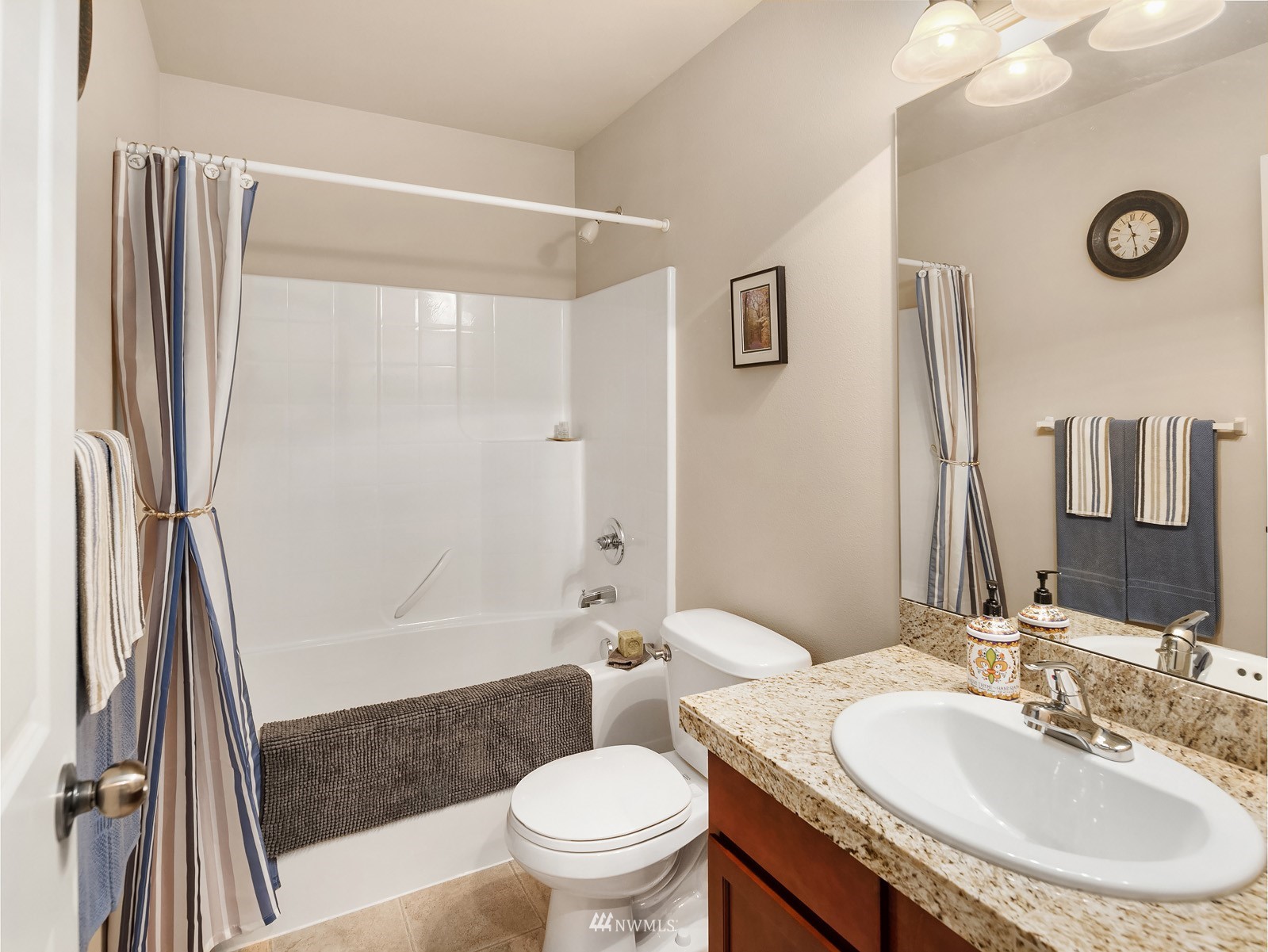 21614 11th Drive Southeast Bothell, WA 98021 - Photo 21 of 35 a bathroom with a sink a toilet a mirror and shower