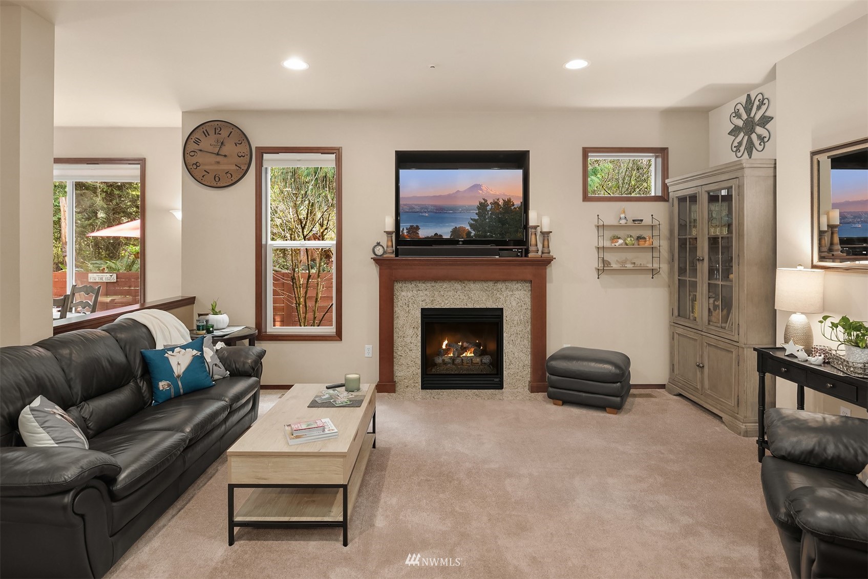 21614 11th Drive Southeast Bothell, WA 98021 - Photo 3 of 35 a living room with furniture a flat screen tv and a fireplace