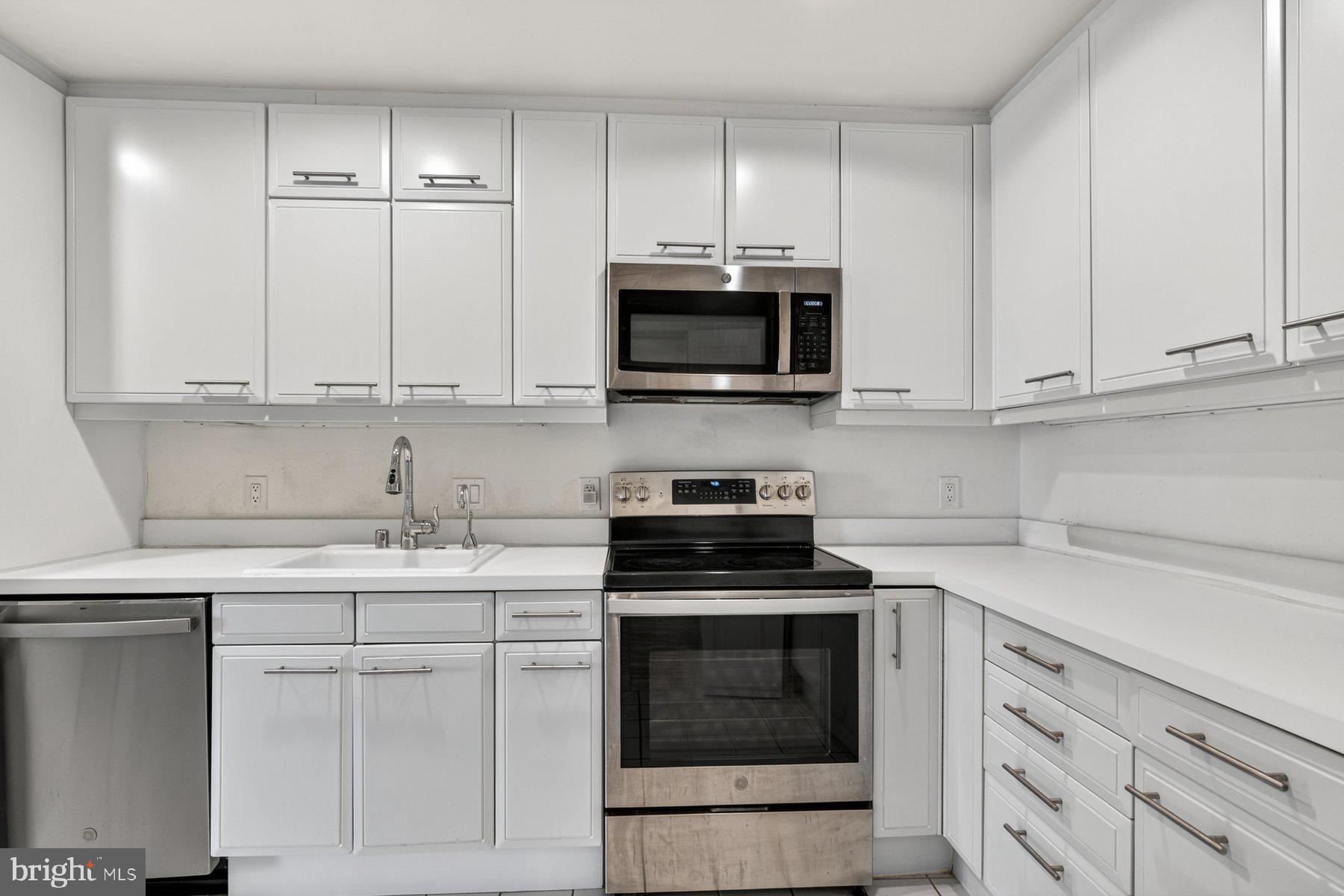 3801 Canterbury Road, Unit 403 Baltimore, MD 21218 - Photo 3 of 25 Sleek modern kitchen with white finishes.