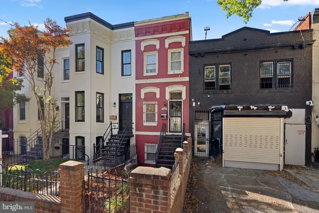 a front view of residential houses with outdoor space