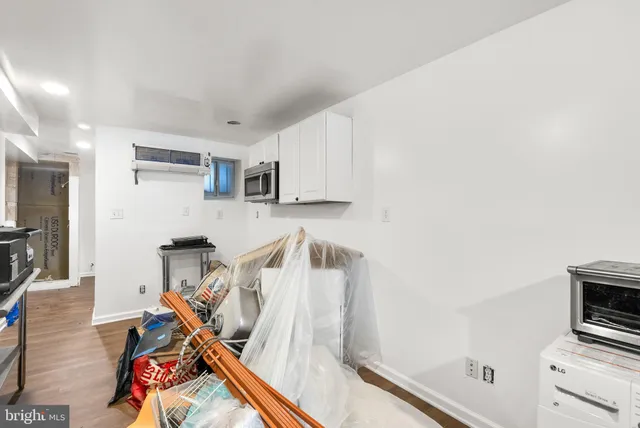 a utility room with dryer washer and a view of living room
