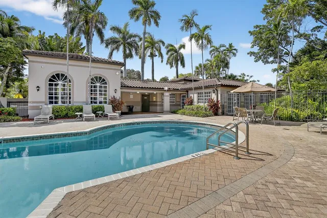 a view of a house with a swimming pool and a chairs