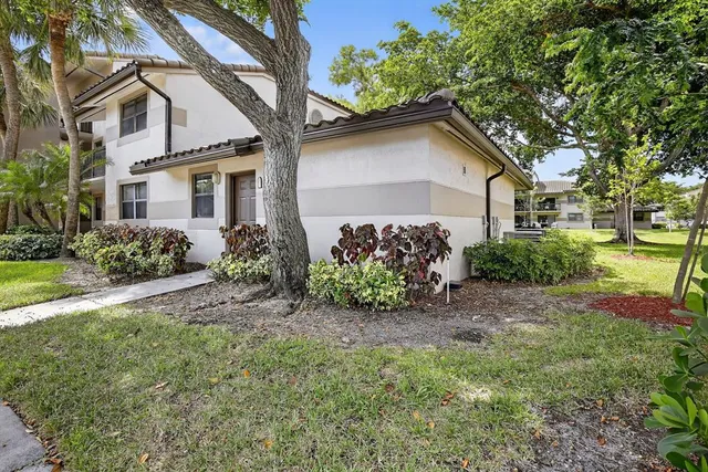 a view of a house with a yard and plants
