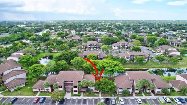 an aerial view of residential houses with outdoor space and trees