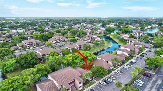 an aerial view of residential houses with outdoor space and trees