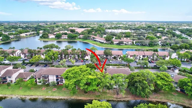an aerial view of a houses with outdoor space and lake view in back