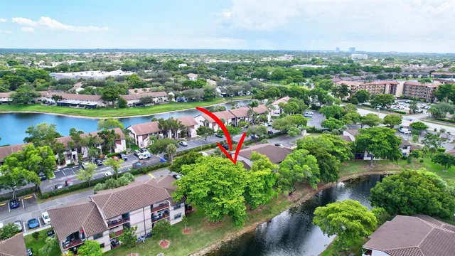 an aerial view of a city with lots of residential buildings ocean and mountain view in back