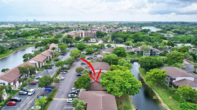 an aerial view of residential houses with outdoor space and trees