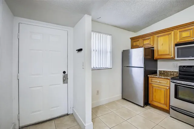 a kitchen with cabinets and stainless steel appliances