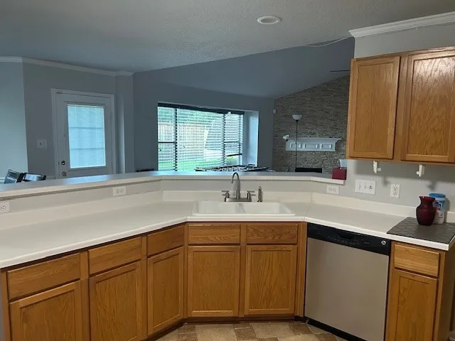 a kitchen with a sink cabinets and window