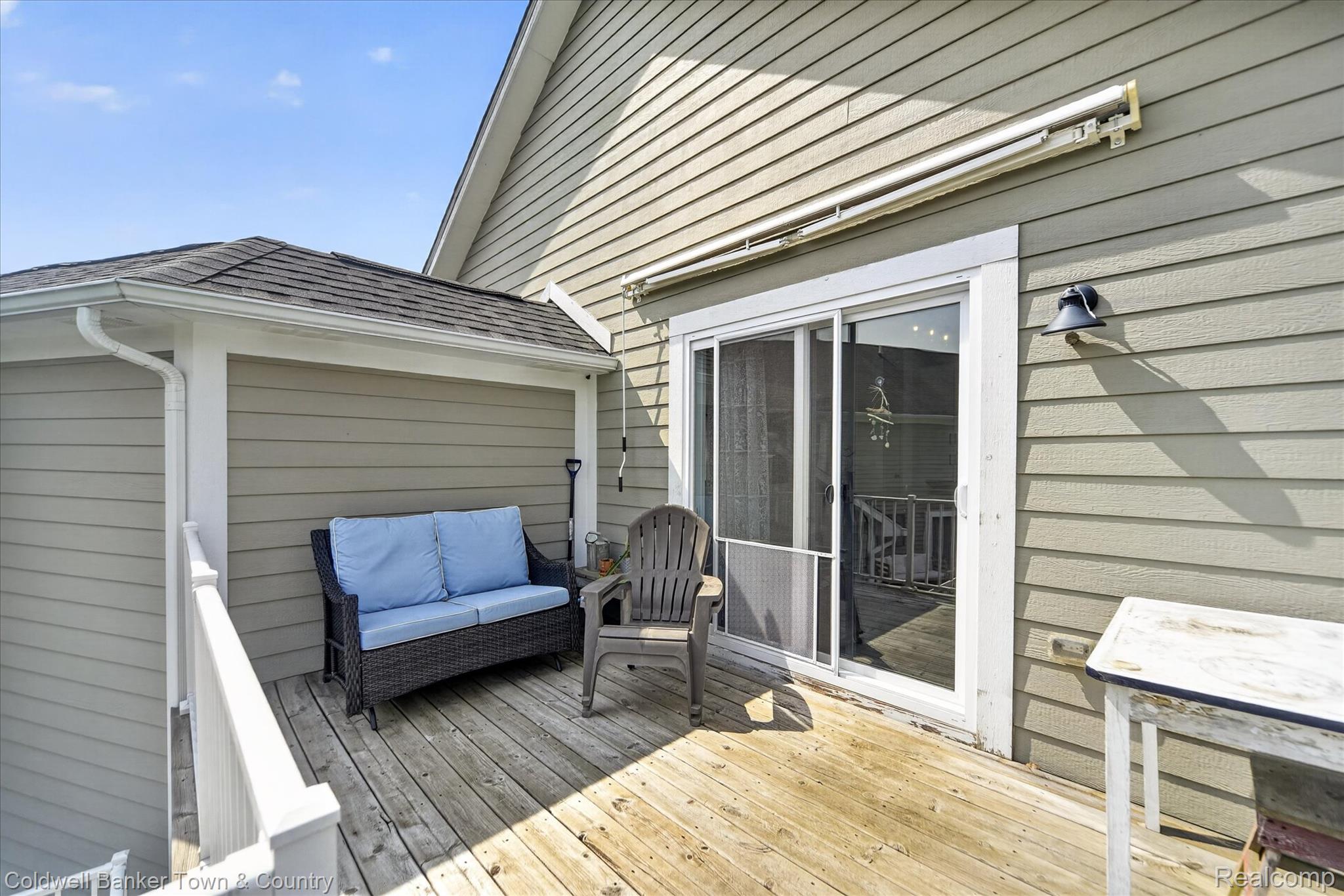 918 Gray Fox Court Howell, MI 48843 - Photo 61 of 84 Outdoor deck space featuring wood decking, tan horizontal siding, white trim, and a sliding glass door