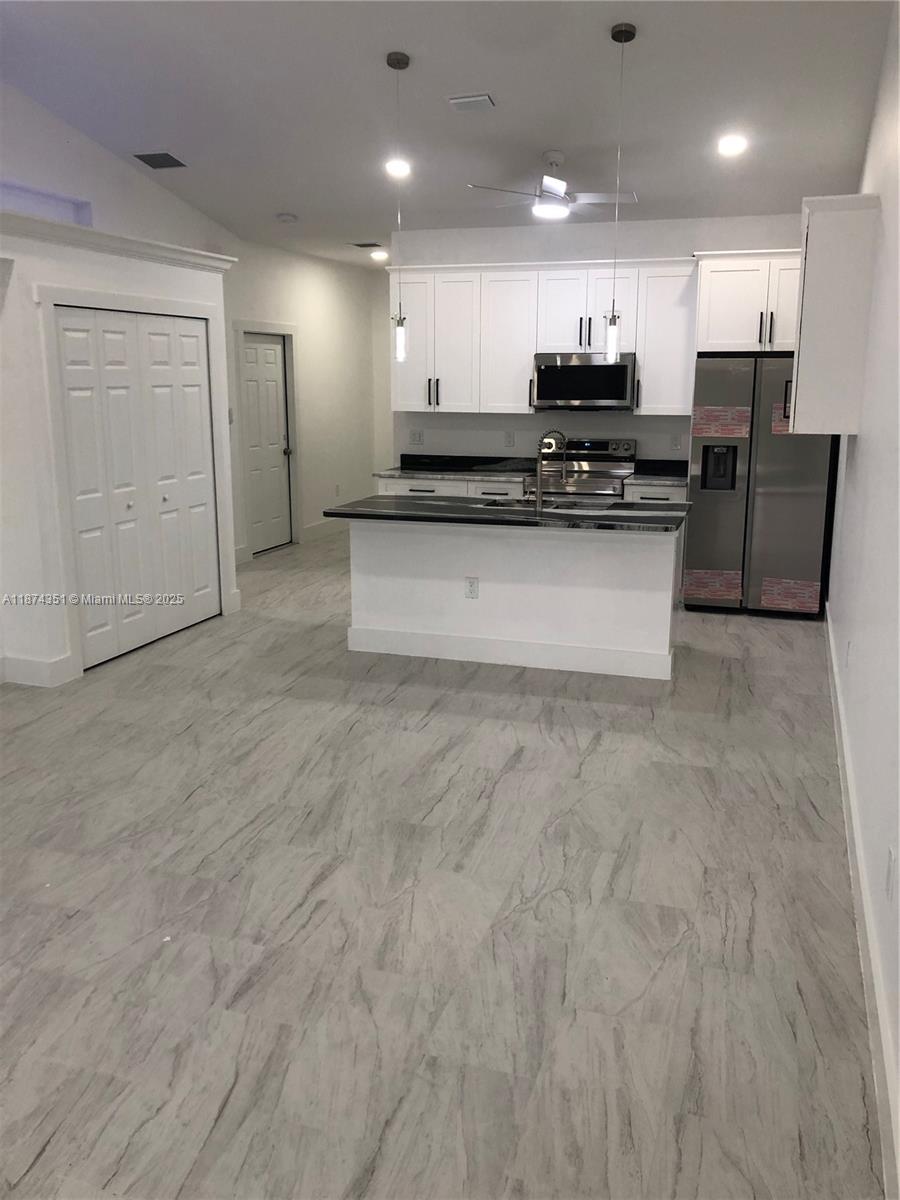 4572 Golfview Boulevard, Unit 1 Lehigh Acres, FL 33973 - Photo 2 of 3 a view of kitchen with refrigerator sink and cabinets