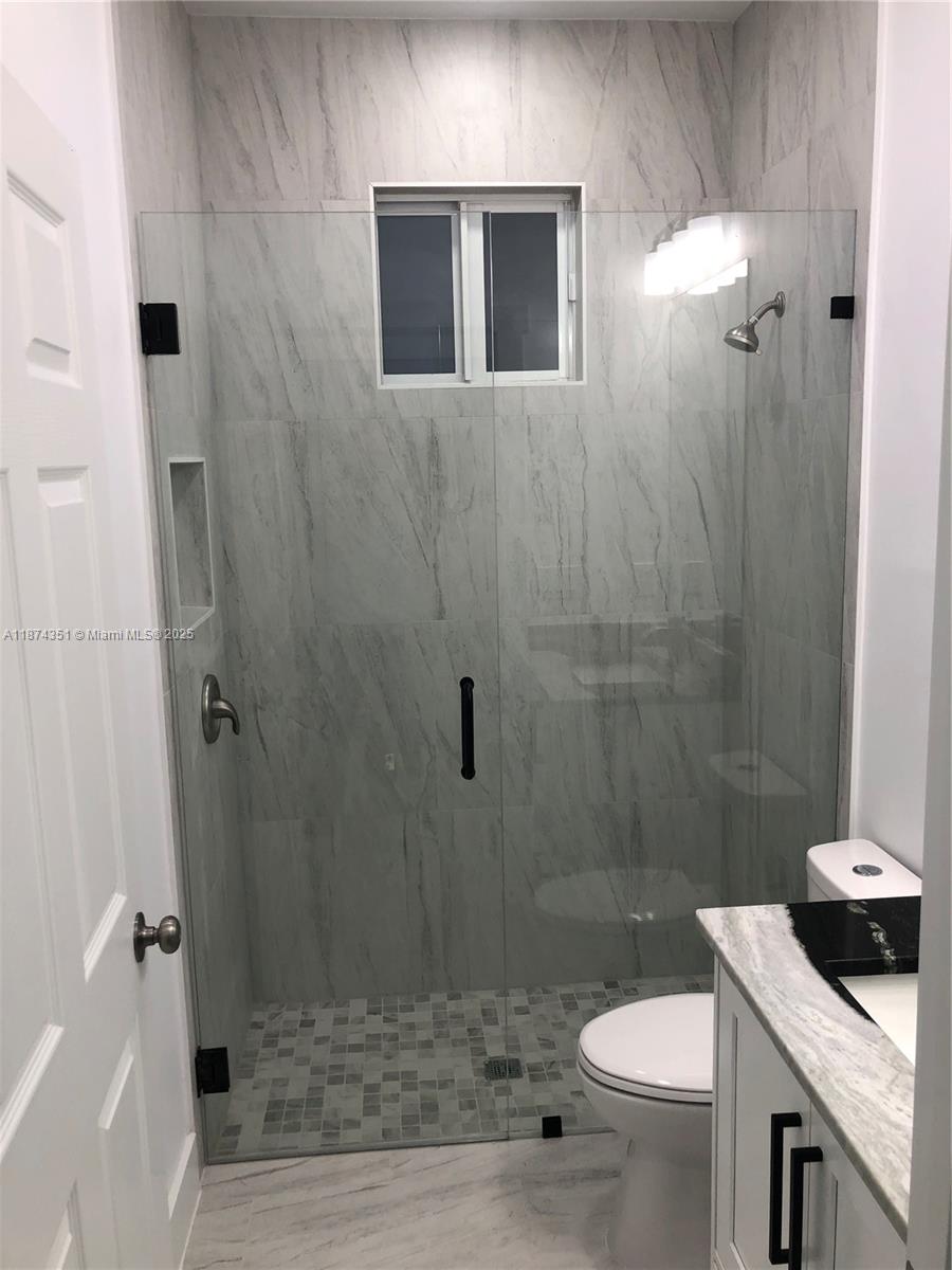 4572 Golfview Boulevard, Unit 1 Lehigh Acres, FL 33973 - Photo 3 of 3 a bathroom with a sink a toilet and shower