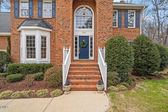a view of an entryway with wooden floor and door