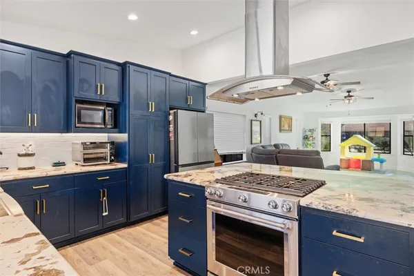 a kitchen with granite countertop cabinets stainless steel appliances and a counter space