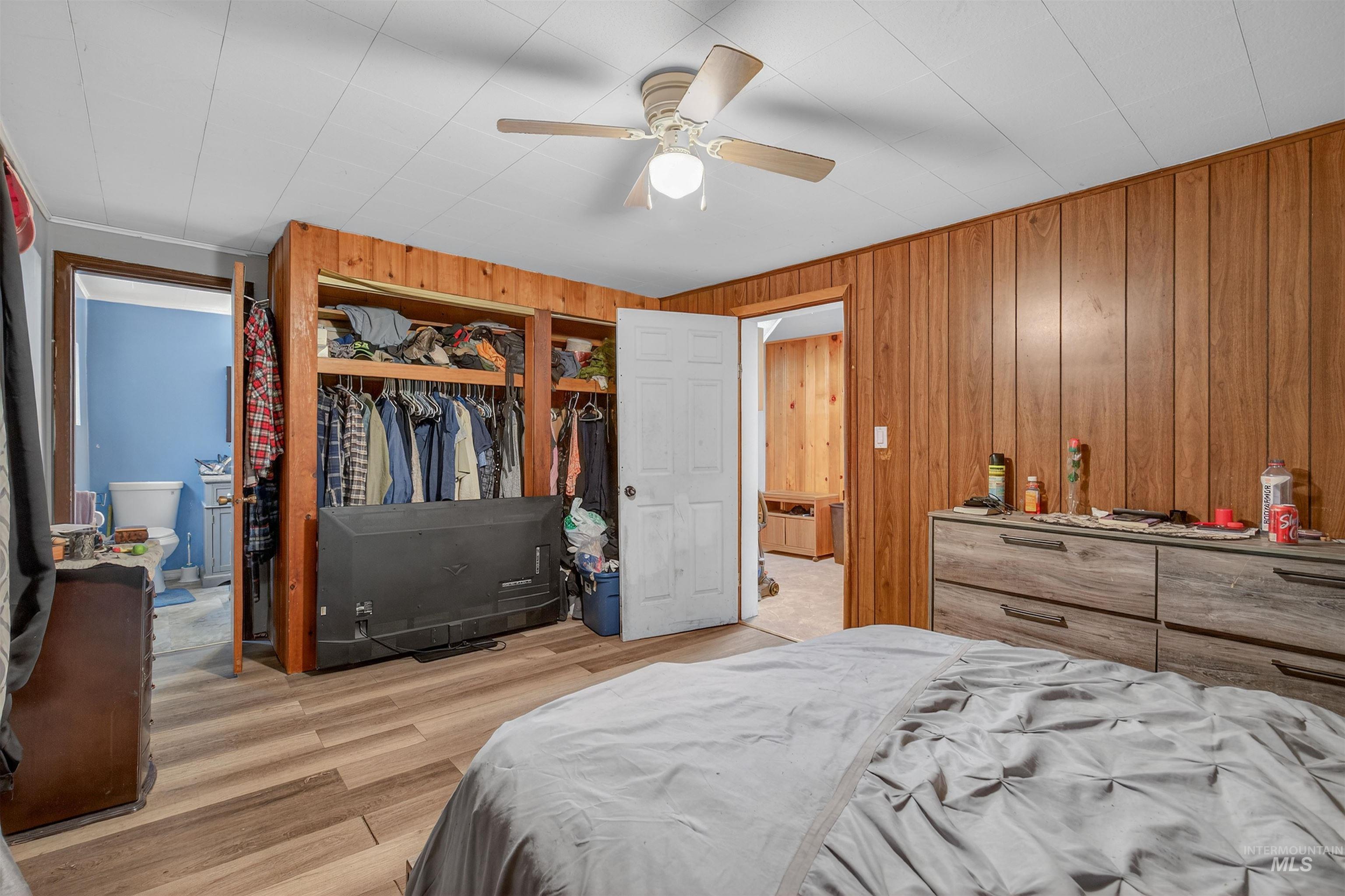 307 Esther Street Kooskia, ID 83539 - Photo 11 of 37 Bedroom with a closet, light wood-style floors, wood walls, and a ceiling fan