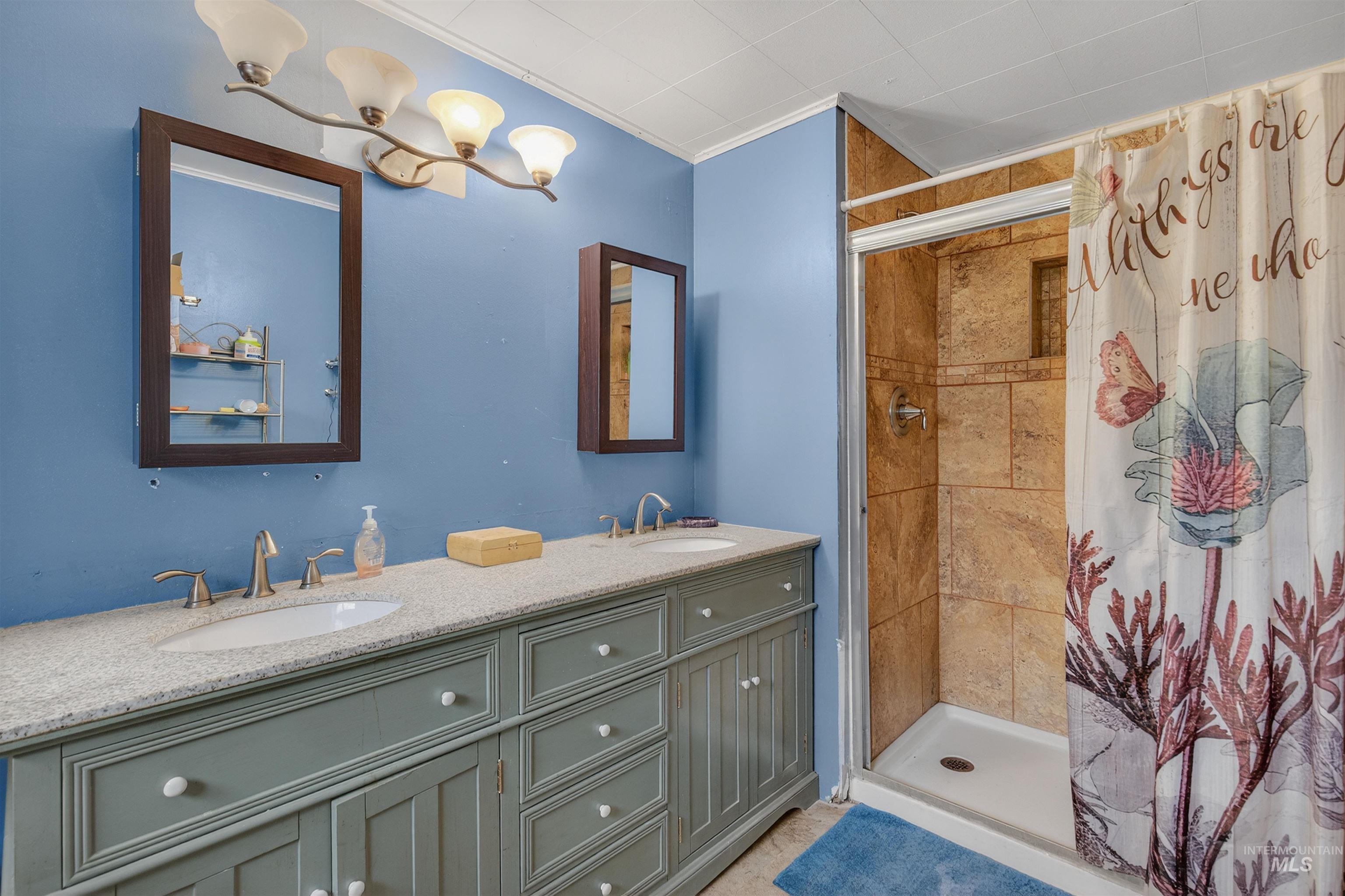 307 Esther Street Kooskia, ID 83539 - Photo 13 of 37 Full bath with a stall shower, double vanity, and crown molding