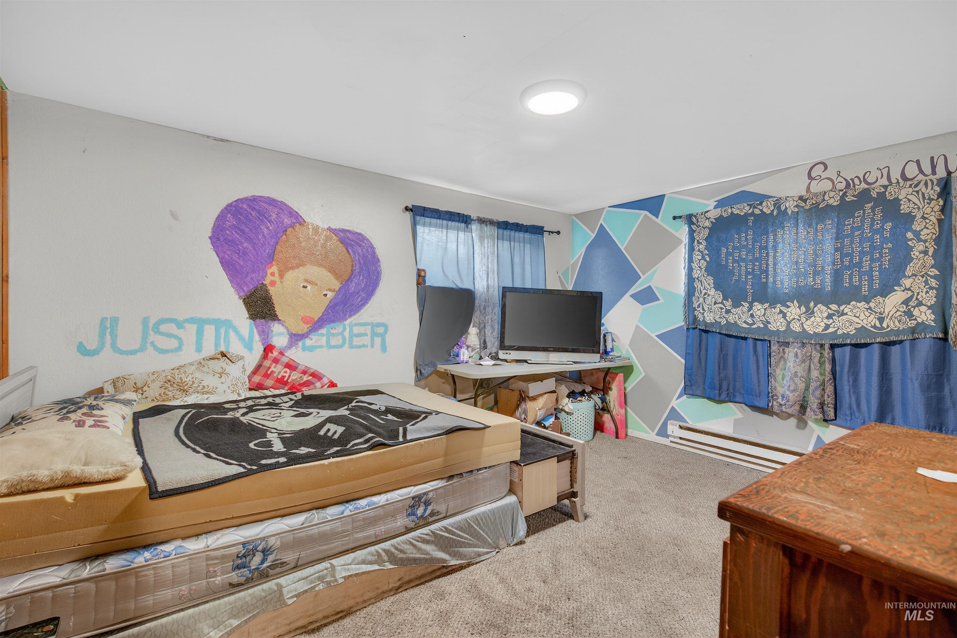 307 Esther Street Kooskia, ID 83539 - Photo 19 of 37 Carpeted bedroom with a baseboard heating unit