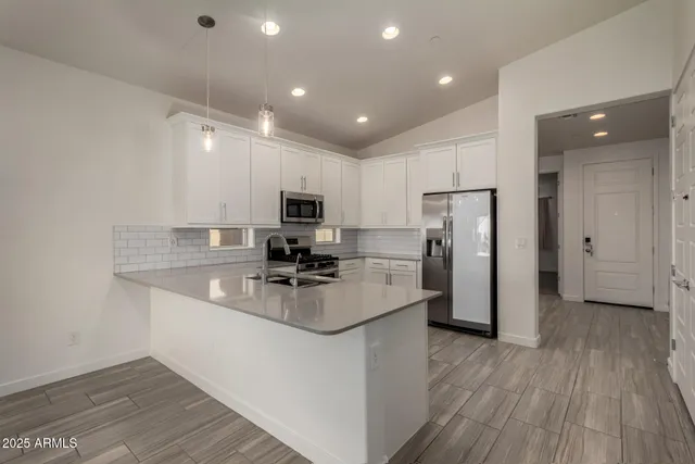 a kitchen with refrigerator and cabinets