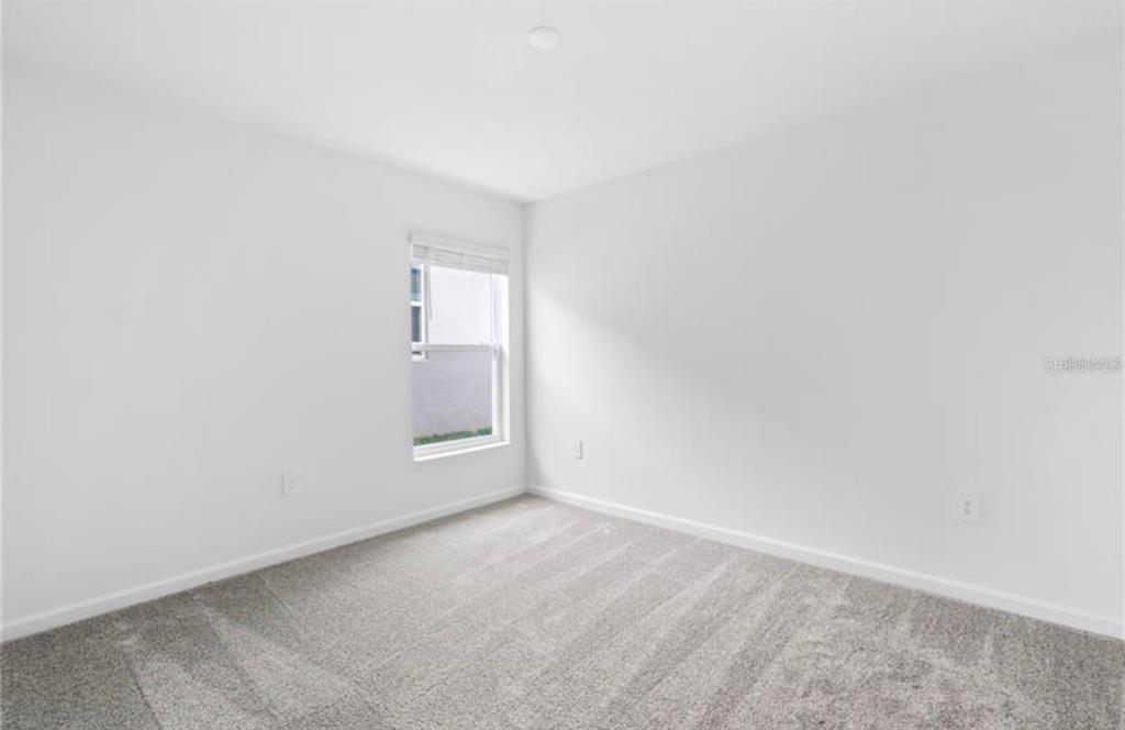 352 Heroic Road Davenport, FL 33837 - Photo 12 of 19 a view of an empty room and a window