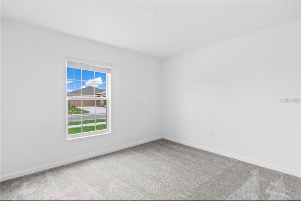 352 Heroic Road Davenport, FL 33837 - Photo 13 of 19 an empty room with windows