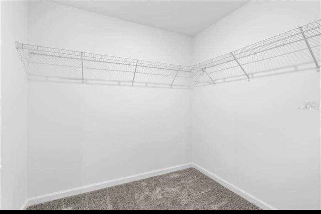 352 Heroic Road Davenport, FL 33837 - Photo 14 of 19 a view of a room with racks on the wall