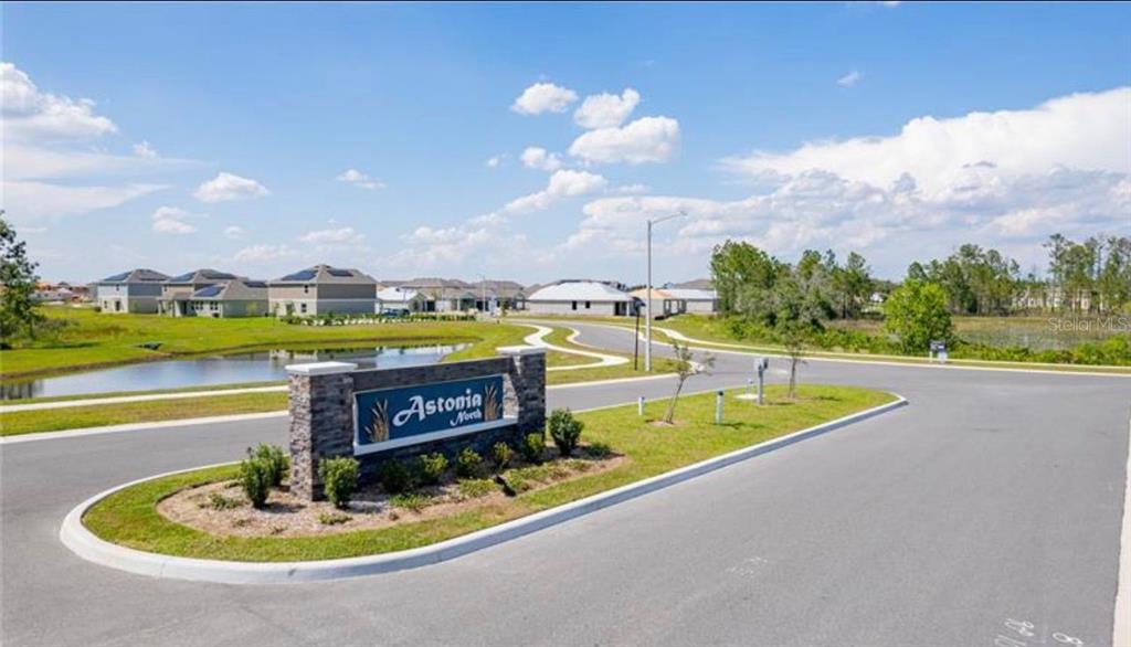 352 Heroic Road Davenport, FL 33837 - Photo 19 of 19 a view of a swimming pool with an outdoor seating and a garden