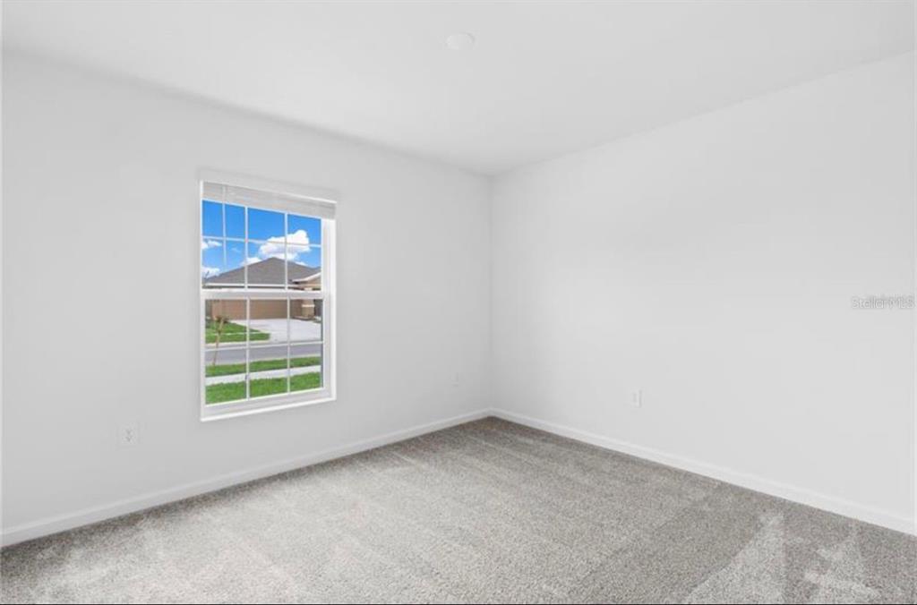 352 Heroic Road Davenport, FL 33837 - Photo 9 of 19 an empty room with windows