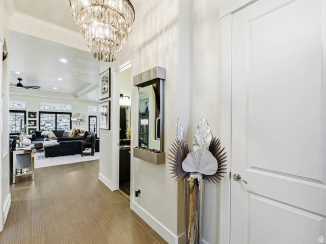 1154 Sunset Dunes Way Draper, UT 84020 - Photo 10 of 50 Hallway with wood finished floors and a chandelier